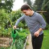 Young man watering vegetables in garden, illustrating resident wellbeing in Henley FM SIPUT II Impact Report 2025 on supported housing for vulnerable adults in UK.