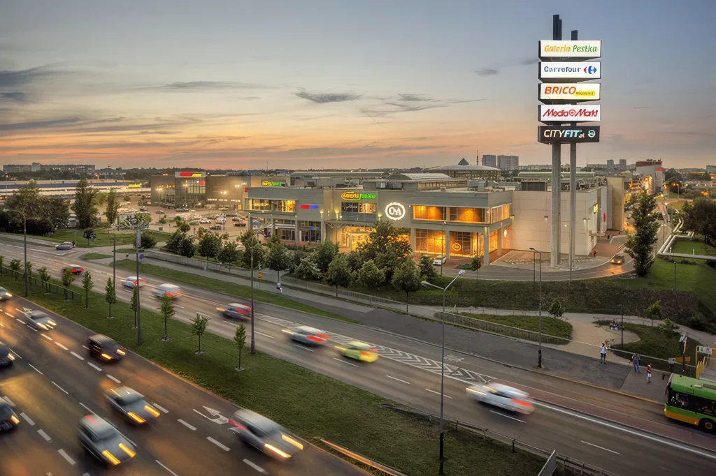 Galeria Pestka shopping centre illuminated at dusk in Poznań, Poland